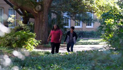 Two student walk together on the historic Horseshoe.