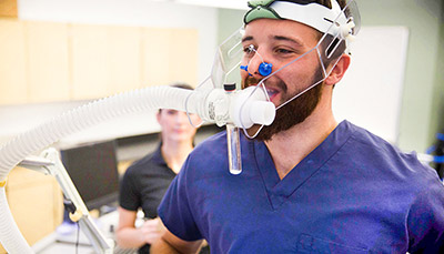 Student monitoring a physical activity test on a patient