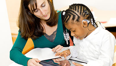USC student working with an elementary student in a clinical setting