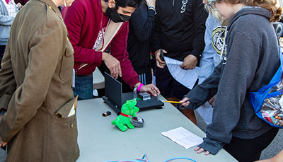 Person giving a physics demonstration.