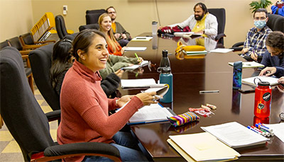 Students sitting around conference table.