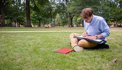 Student studying on the historic horseshoe. 