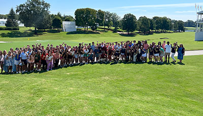 Large group of people on a golf course. 