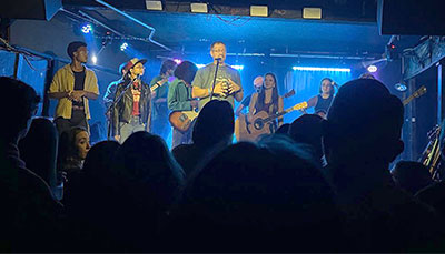 Group of students on stage at a fundraising event.