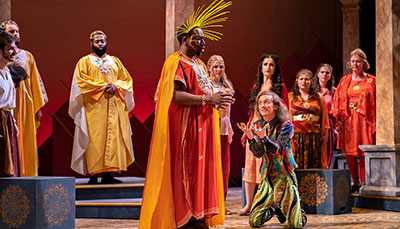 Opera performers on stage in full costume.