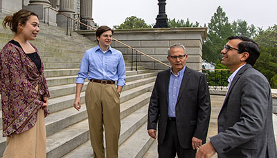 Group of people standing on the statehouse steps. 